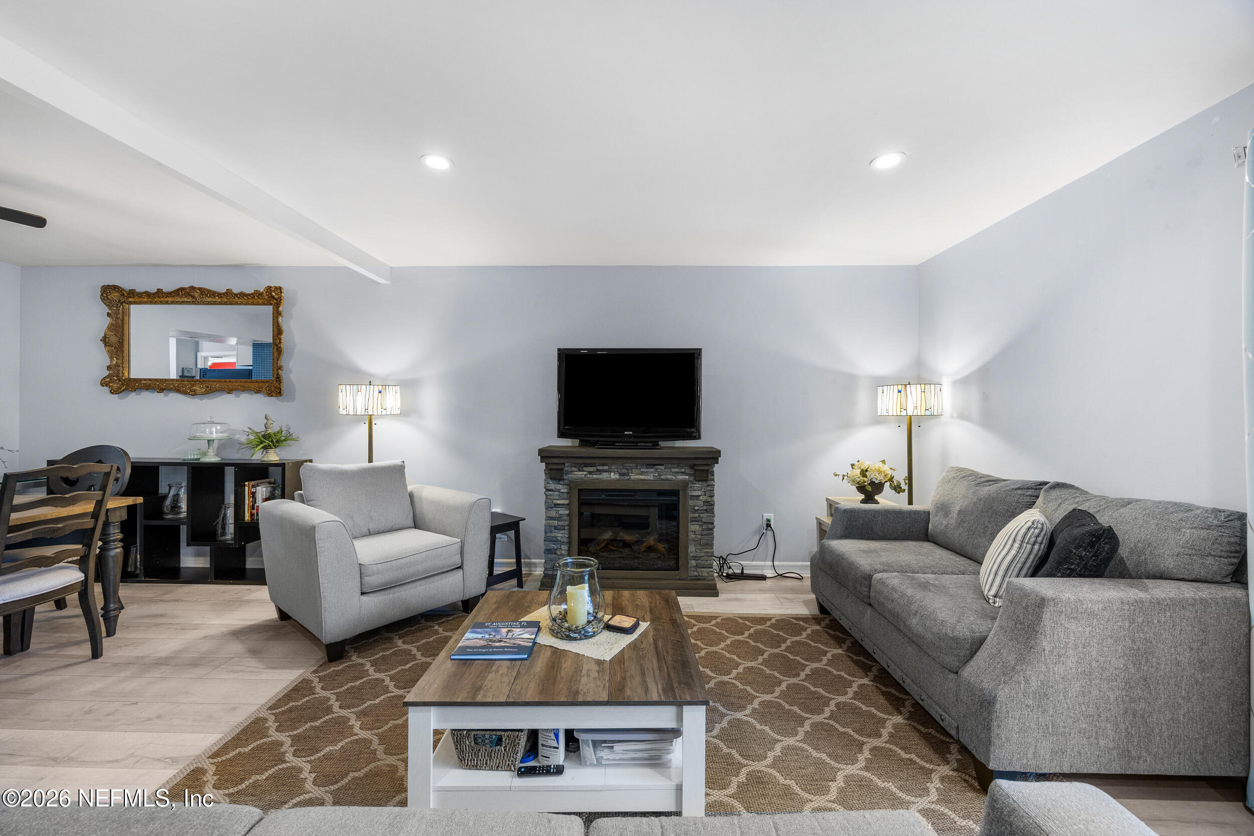 7852 Playa Del Rey Court Jacksonville, FL 32256 - Photo 14 of 33 a living room with furniture a flat screen tv and a fireplace