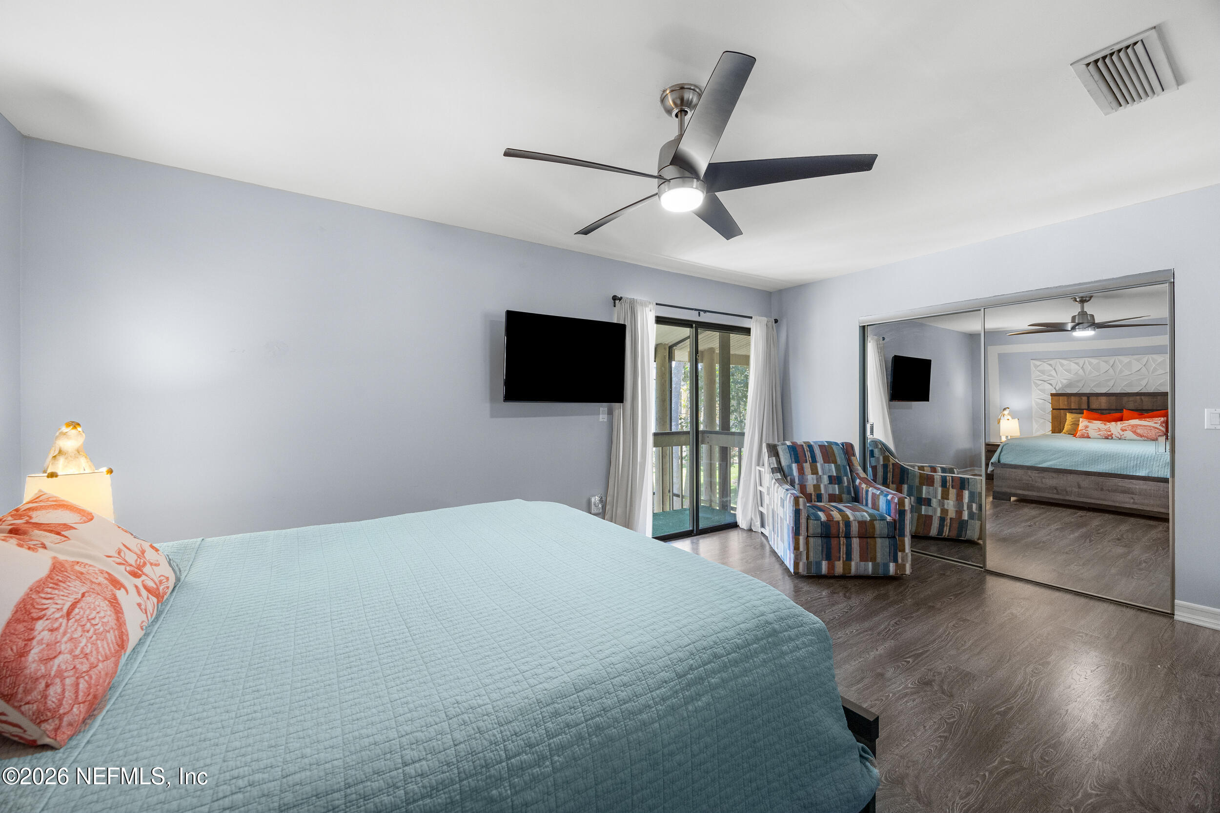 7852 Playa Del Rey Court Jacksonville, FL 32256 - Photo 19 of 33 a bedroom with a bed and a flat screen tv