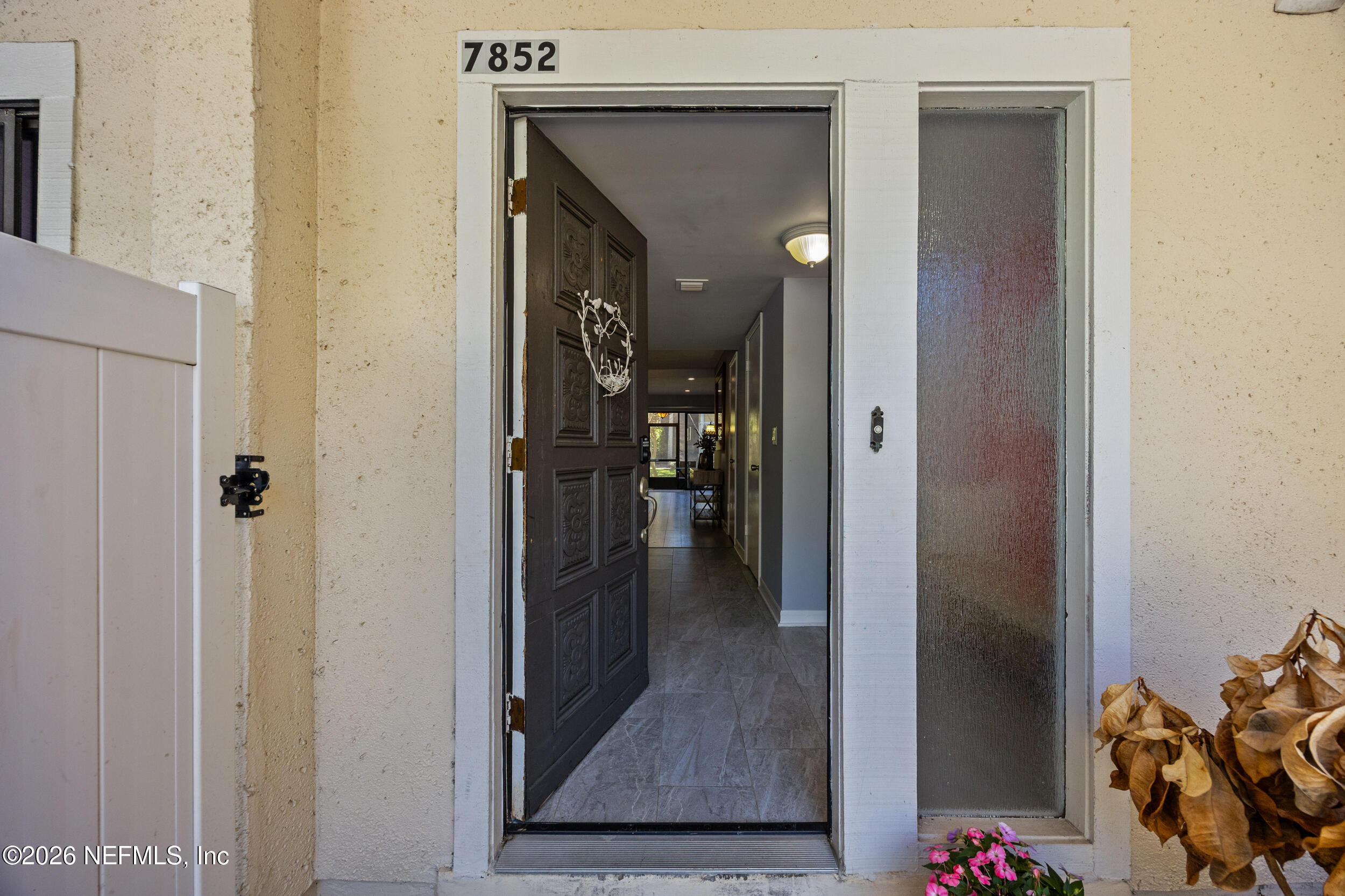 7852 Playa Del Rey Court Jacksonville, FL 32256 - Photo 2 of 33 a view of a hallway with wooden floor and a livingroom