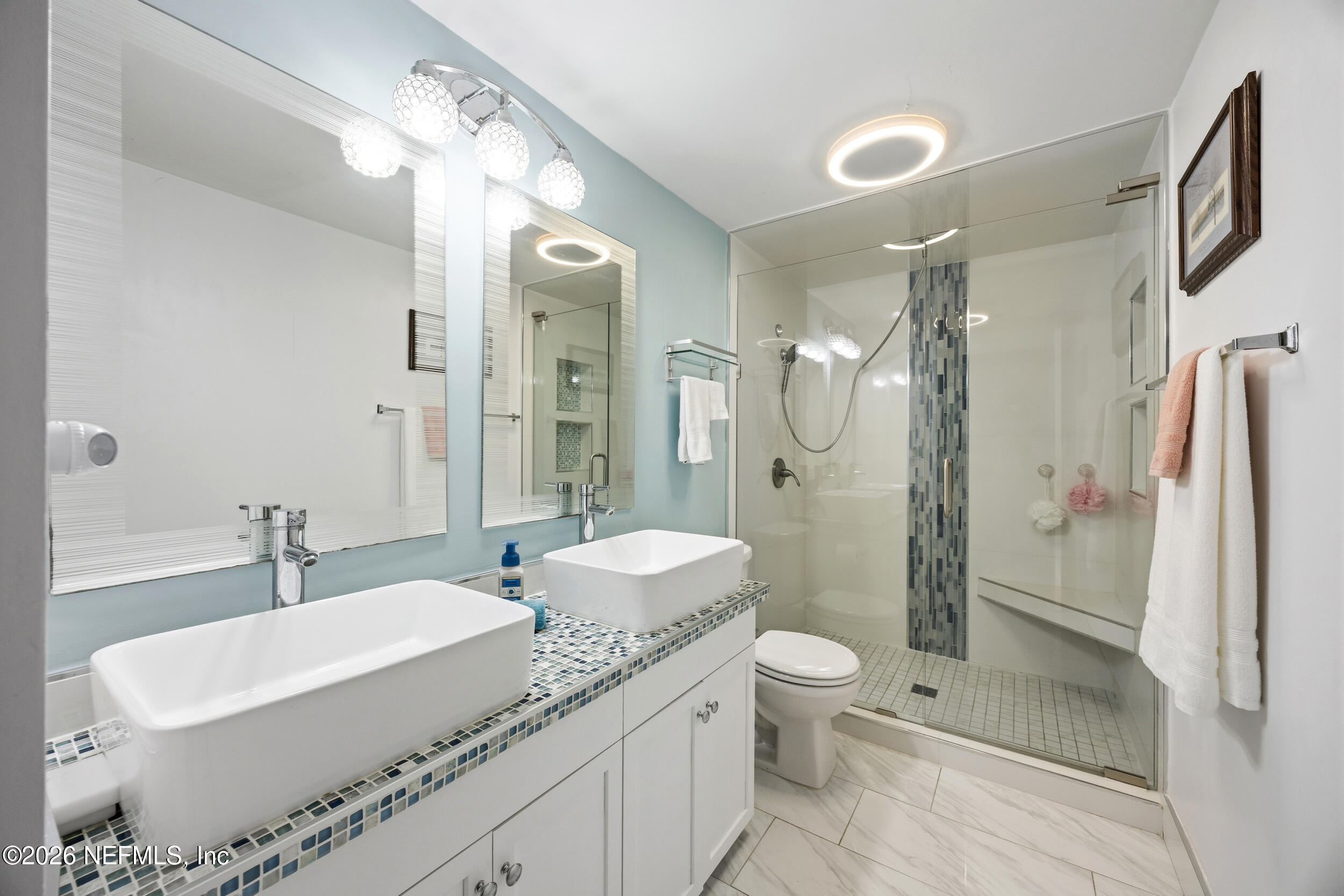 7852 Playa Del Rey Court Jacksonville, FL 32256 - Photo 21 of 33 a bathroom with a granite countertop double vanity sink mirror double shower and a toilet