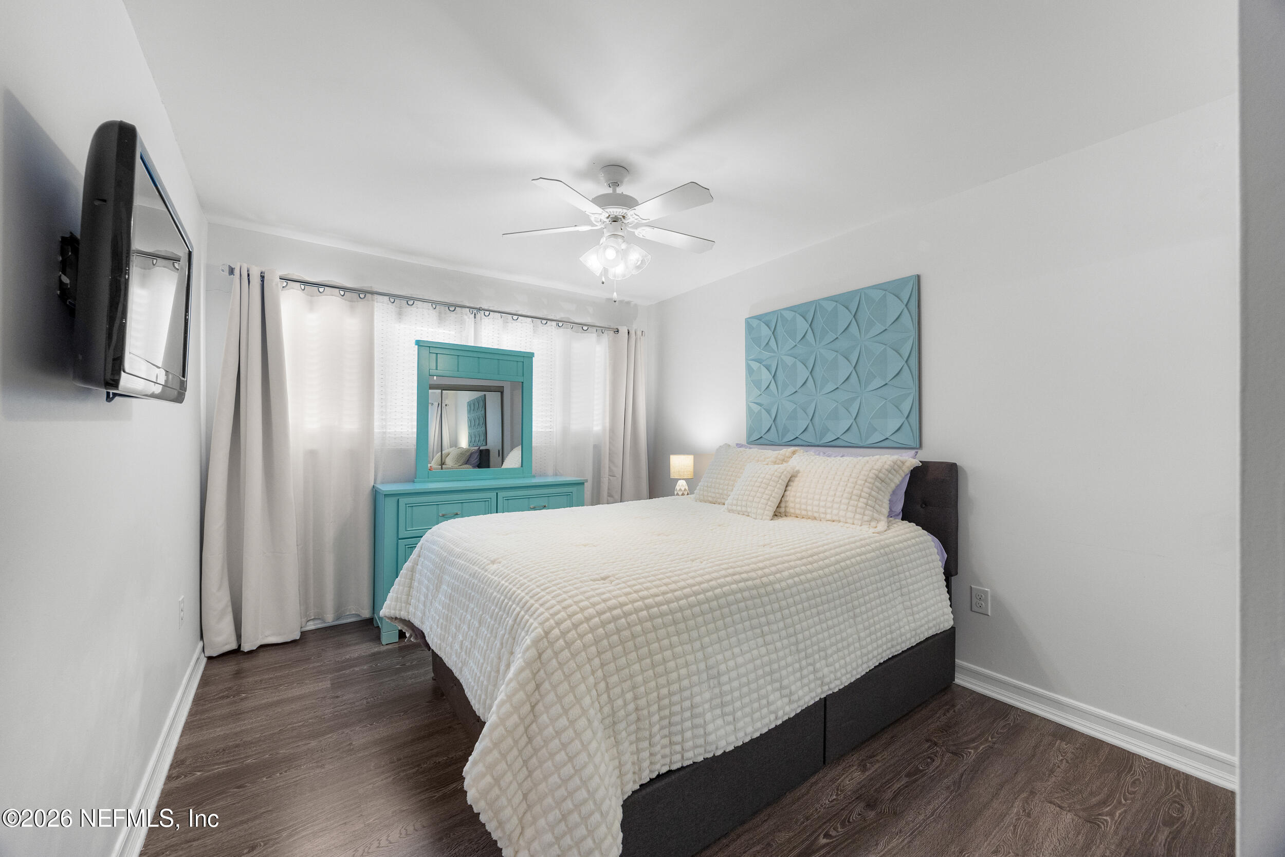 7852 Playa Del Rey Court Jacksonville, FL 32256 - Photo 22 of 33 a bedroom with a large bed and a chandelier