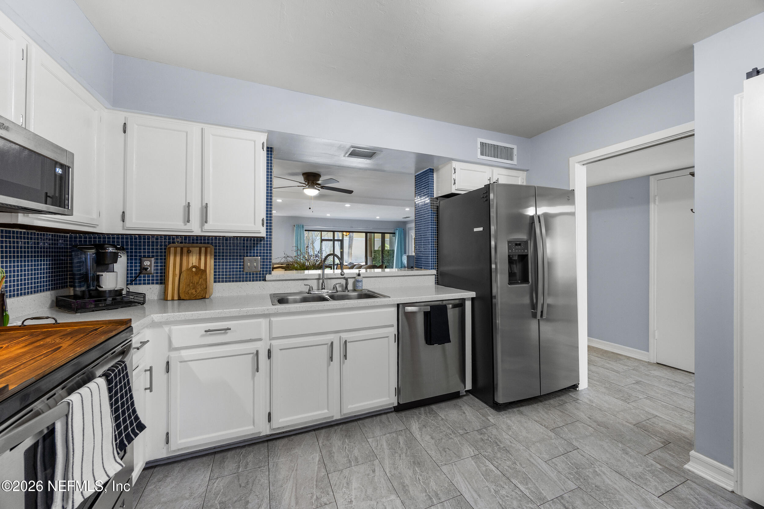 7852 Playa Del Rey Court Jacksonville, FL 32256 - Photo 4 of 33 a kitchen with stainless steel appliances granite countertop a refrigerator stove and sink