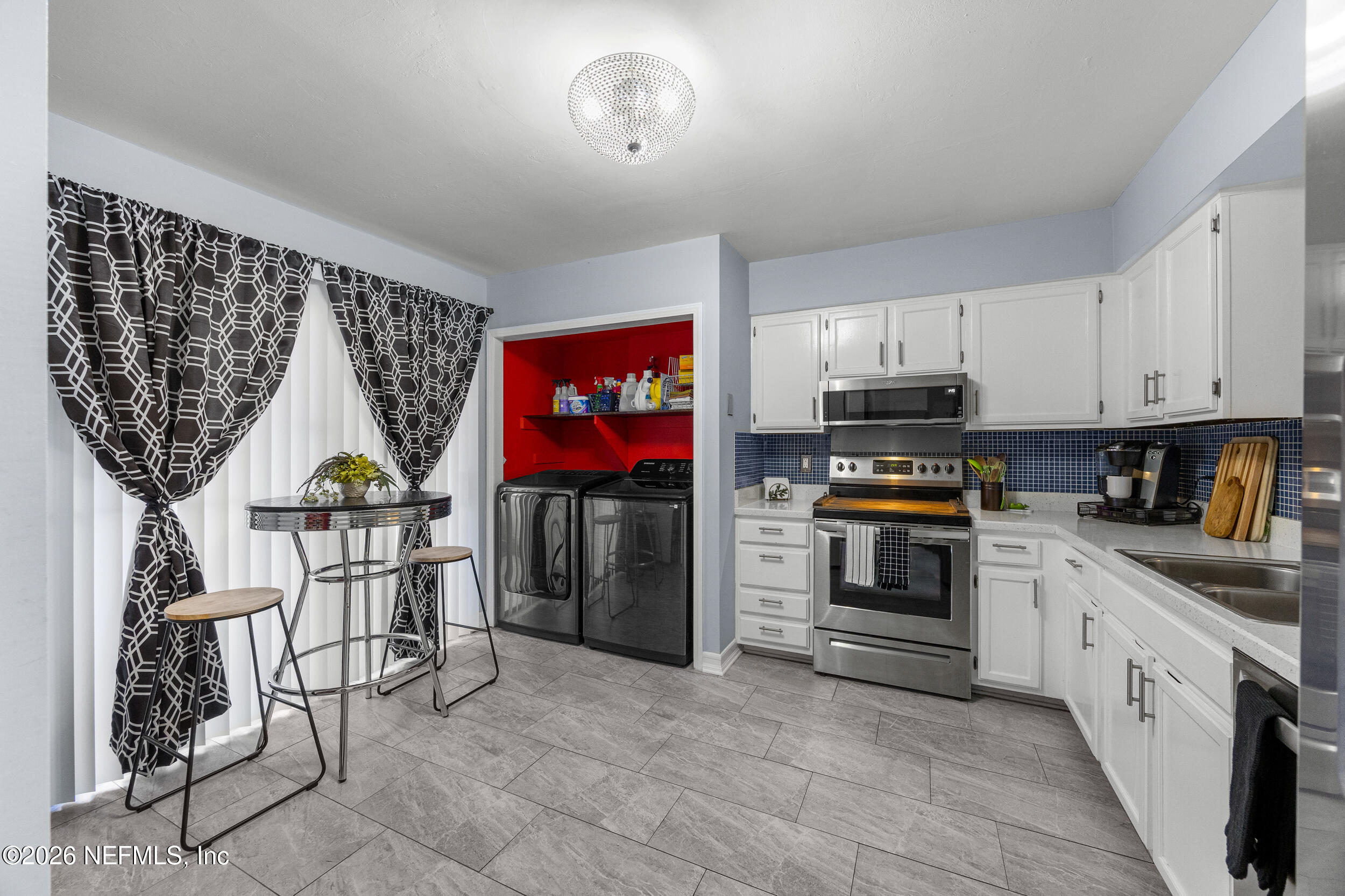 7852 Playa Del Rey Court Jacksonville, FL 32256 - Photo 9 of 33 a kitchen with stainless steel appliances granite countertop a stove a sink and a refrigerator