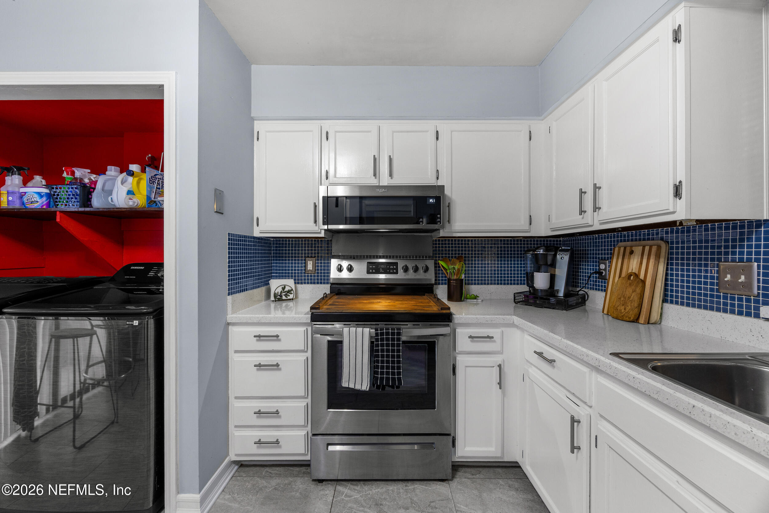 7852 Playa Del Rey Court Jacksonville, FL 32256 - Photo 10 of 33 a kitchen with stainless steel appliances granite countertop a stove and cabinets