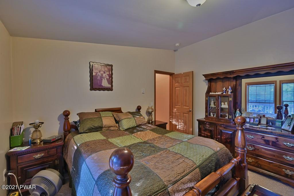 417 Northgate Road Lake Ariel, PA 18436 - Photo 32 of 91 a bedroom with a bed and wooden floor