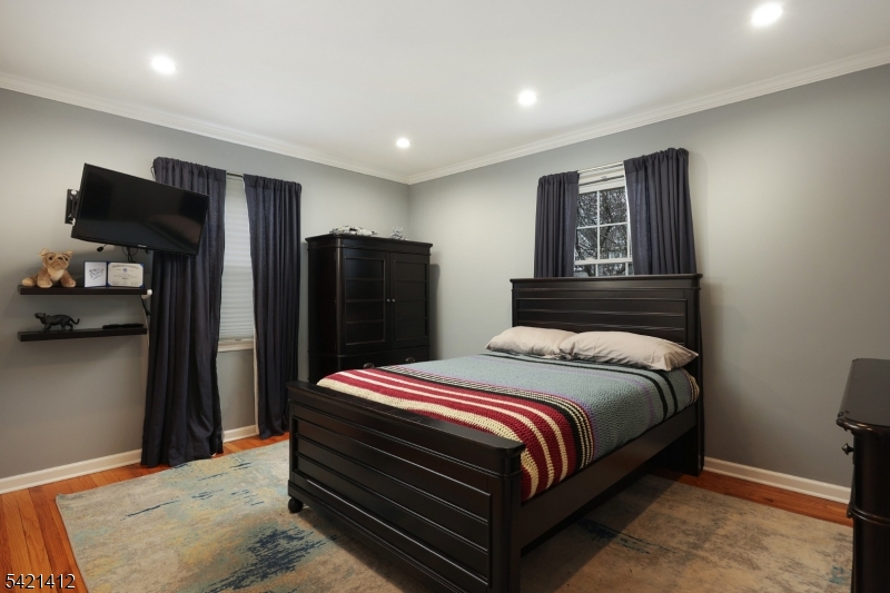 178 Tillotson Road Fanwood, NJ 07023 - Photo 13 of 38 a bedroom with a bed and a refrigerator