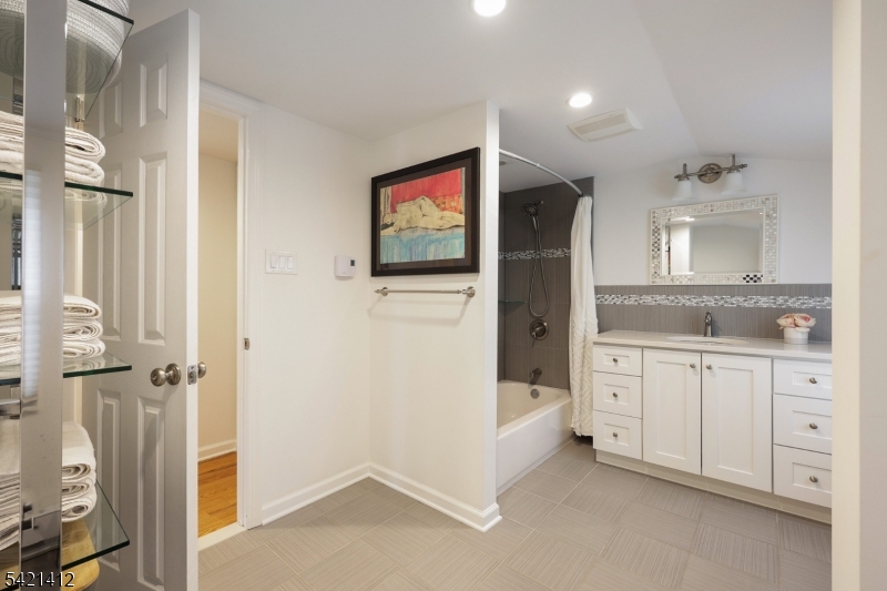 178 Tillotson Road Fanwood, NJ 07023 - Photo 16 of 38 a spacious bathroom with a granite countertop sink mirror and bathtub