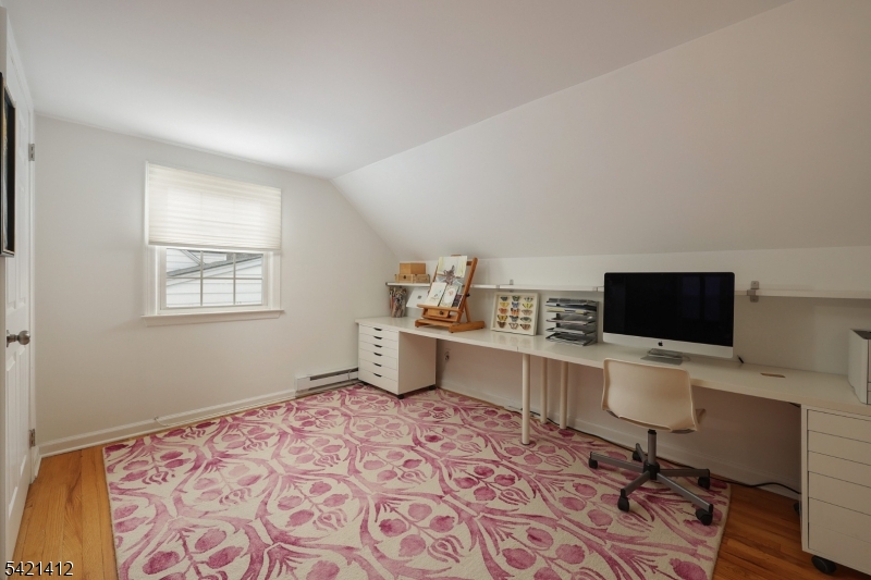 178 Tillotson Road Fanwood, NJ 07023 - Photo 17 of 38 a room with a chair and a flat screen tv