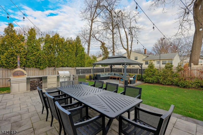 178 Tillotson Road Fanwood, NJ 07023 - Photo 29 of 38 a view of a roof deck with table and chairs a barbeque with wooden floor and fence
