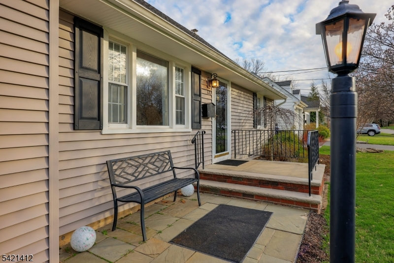 178 Tillotson Road Fanwood, NJ 07023 - Photo 4 of 38 a porch with a bench next to a yard