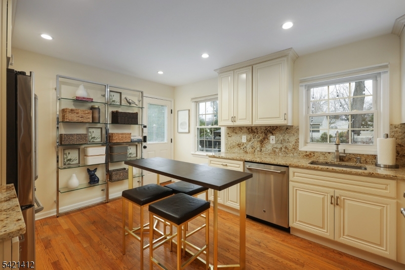 178 Tillotson Road Fanwood, NJ 07023 - Photo 8 of 38 a kitchen with stainless steel appliances granite countertop a stove top oven a sink dishwasher and a refrigerator with wooden floor