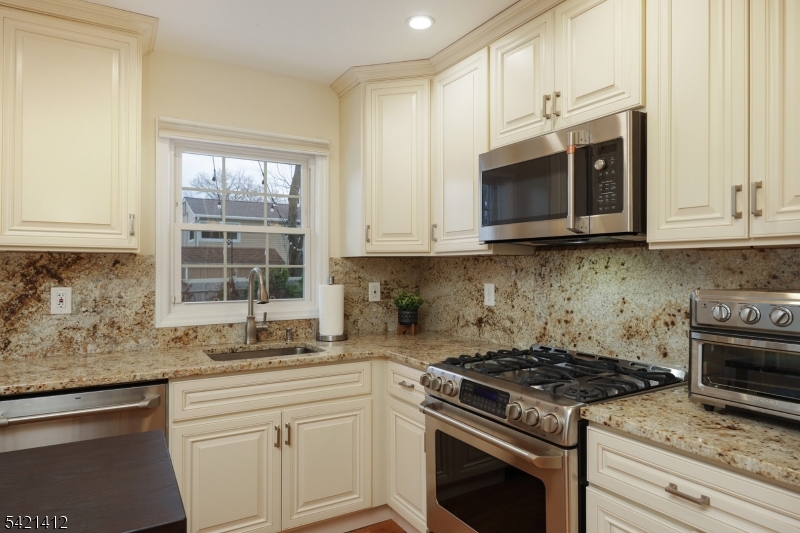 178 Tillotson Road Fanwood, NJ 07023 - Photo 10 of 38 a kitchen with granite countertop white cabinets stainless steel appliances and a sink