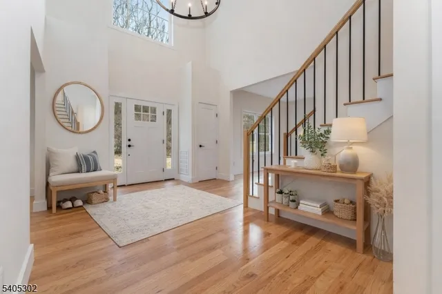 a view of an empty room with wooden floor and glass door