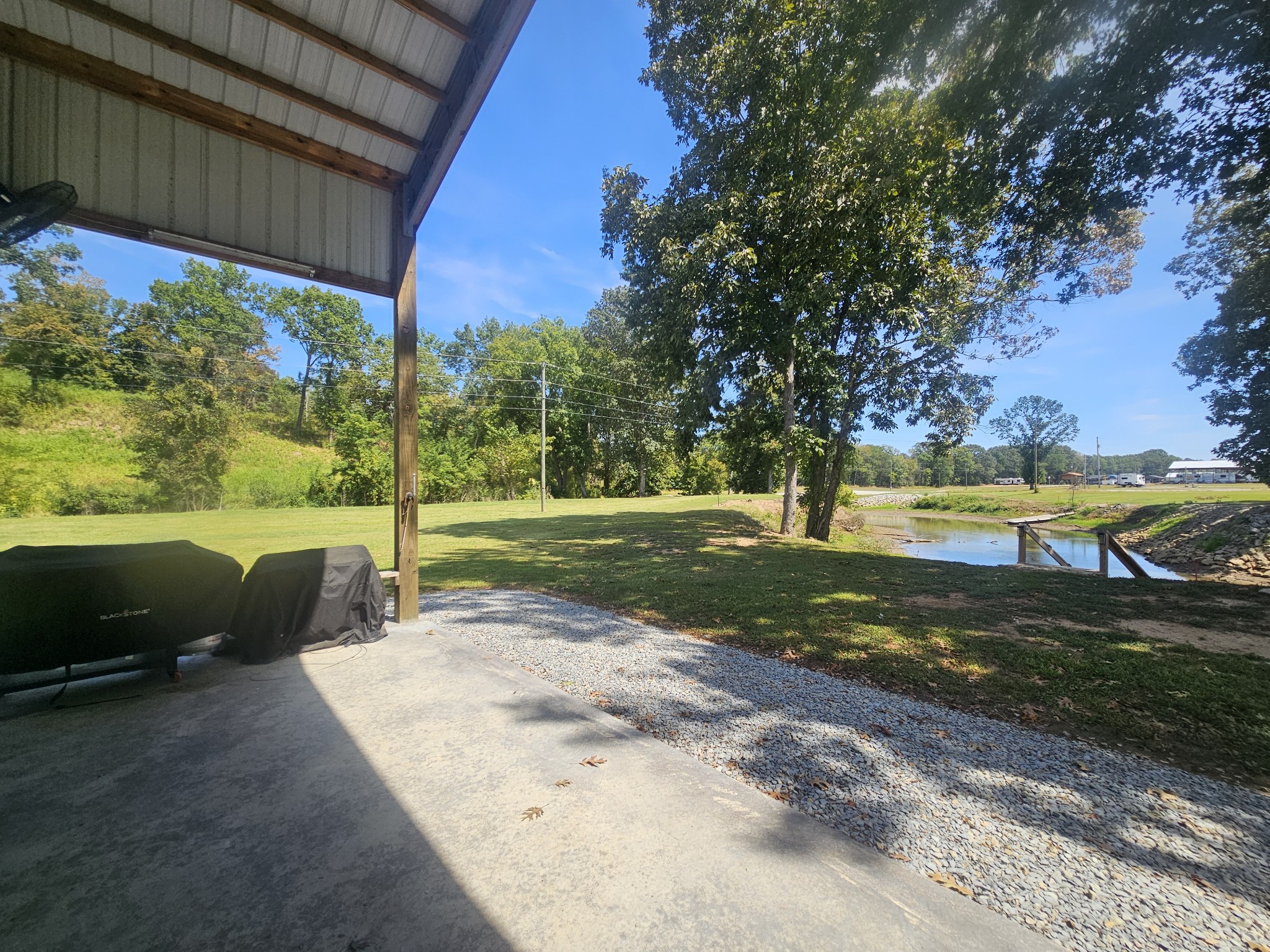 942 Lexi Lane Clifton, TN 38425 - Photo 14 of 33 a view of a backyard with table and chairs under an umbrella
