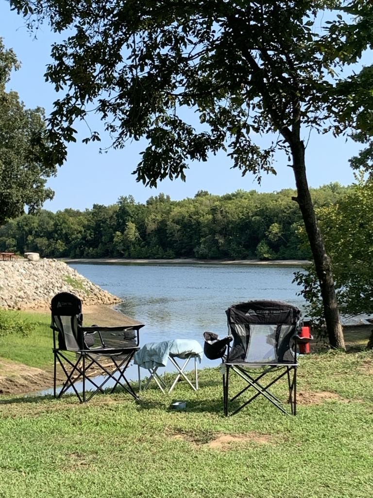 942 Lexi Lane Clifton, TN 38425 - Photo 8 of 33 a view of a lake with table and chairs potted plants and large tree