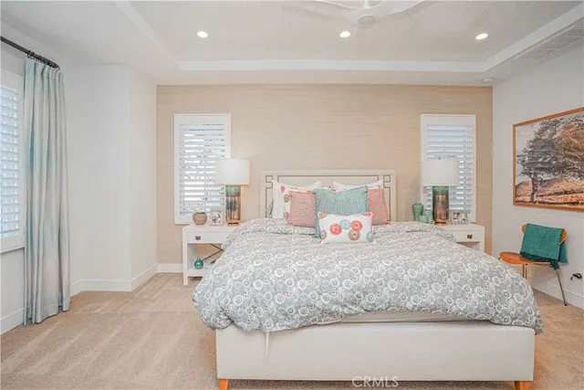 a bedroom with a large bed and wooden floor