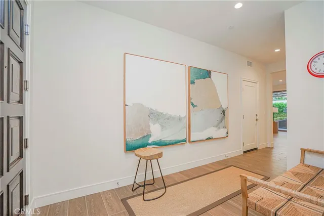 a living room with a table and a potted plant