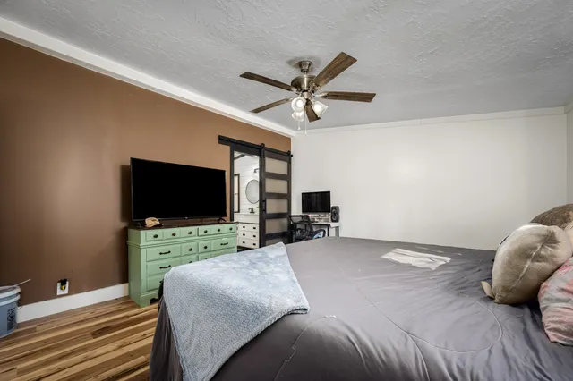 a backyard of a house with barbeque oven and large trees