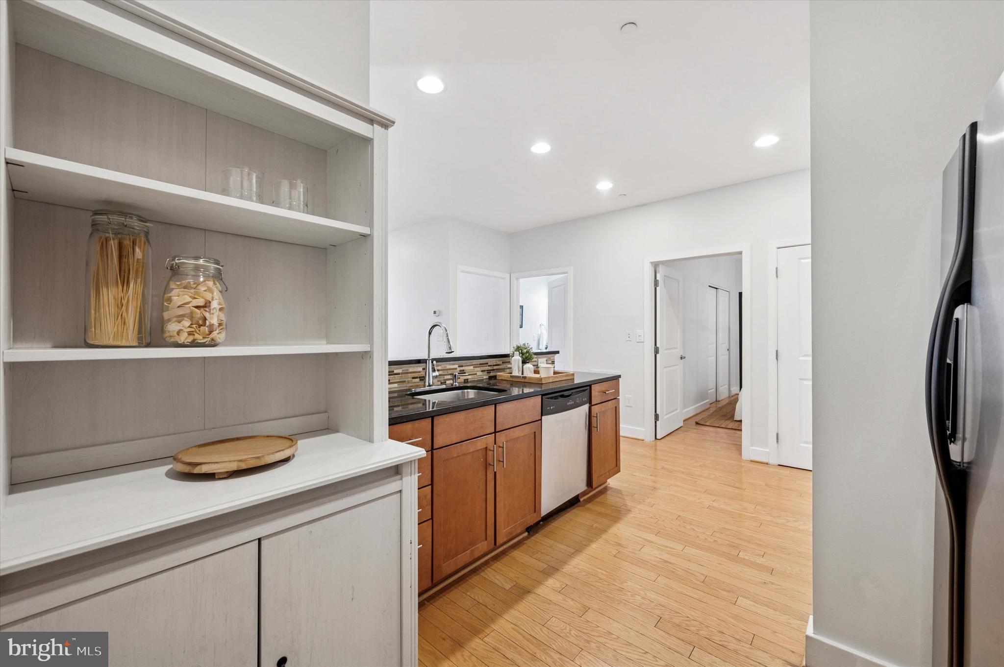 714 Bainbridge Street, Unit 9 Philadelphia, PA 19147 - Photo 12 of 25 a kitchen with stainless steel appliances granite countertop a refrigerator and a stove top oven
