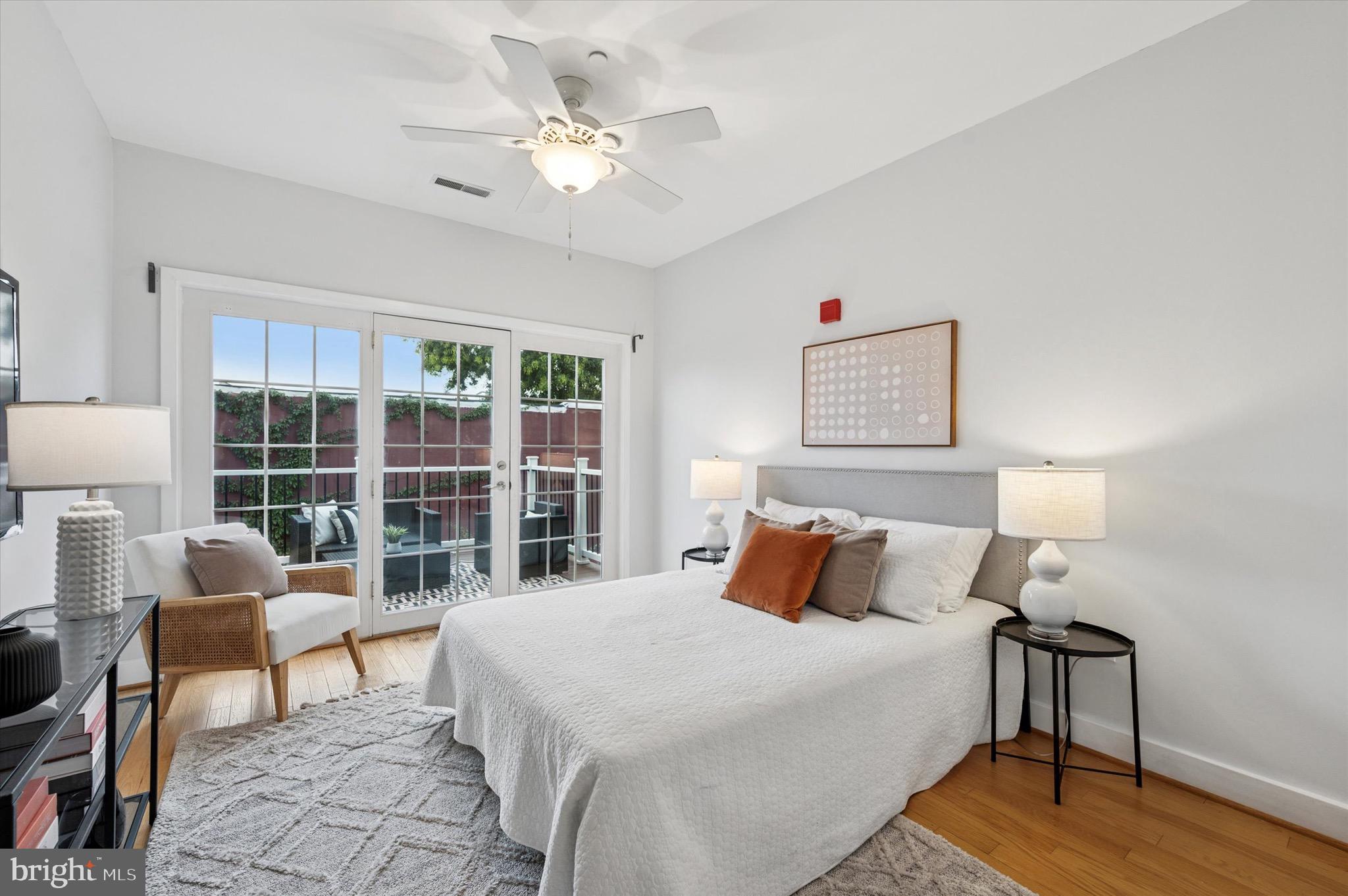 714 Bainbridge Street, Unit 9 Philadelphia, PA 19147 - Photo 14 of 25 a bedroom with a bed a chair and a large window
