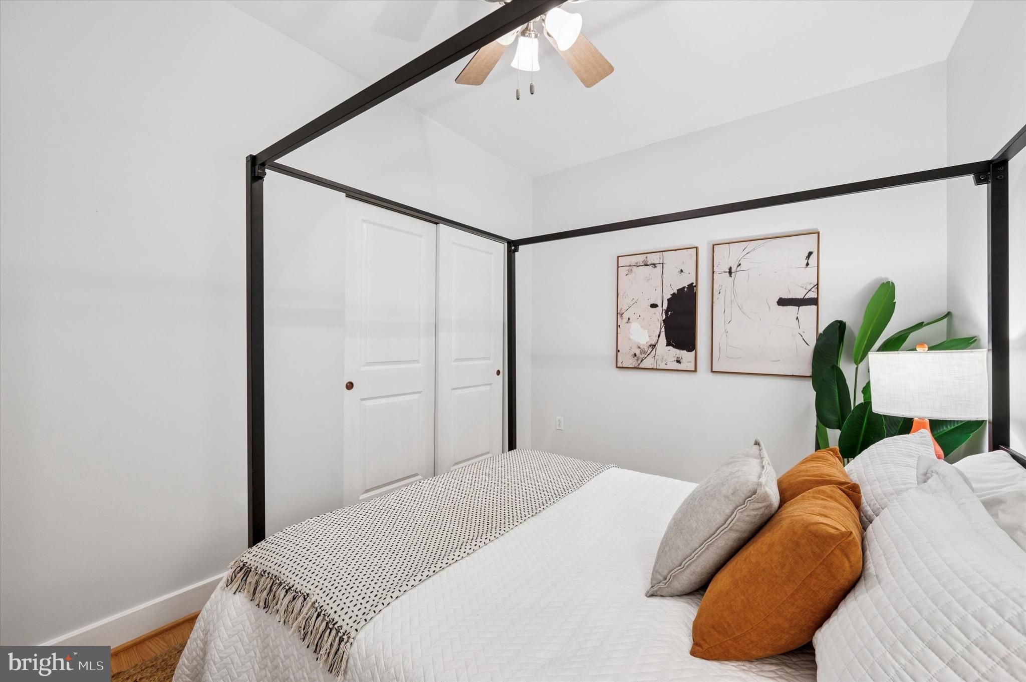 714 Bainbridge Street, Unit 9 Philadelphia, PA 19147 - Photo 19 of 25 a bedroom with a bed and painting on the wall