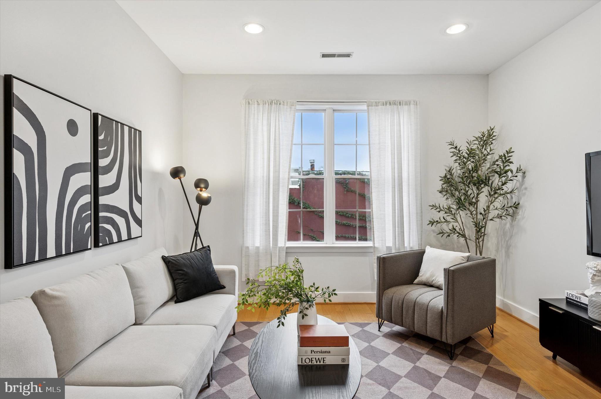 714 Bainbridge Street, Unit 9 Philadelphia, PA 19147 - Photo 4 of 25 a living room with furniture and a floor to ceiling window