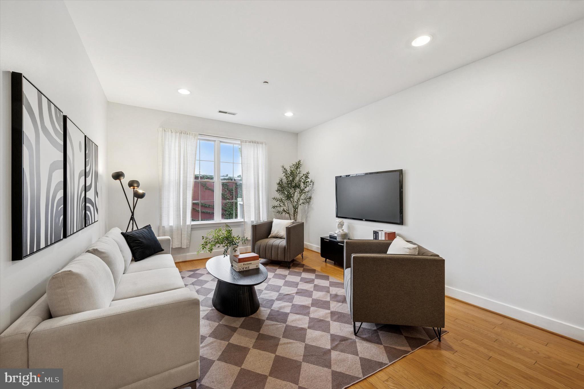 714 Bainbridge Street, Unit 9 Philadelphia, PA 19147 - Photo 5 of 25 a living room with furniture and wooden floor