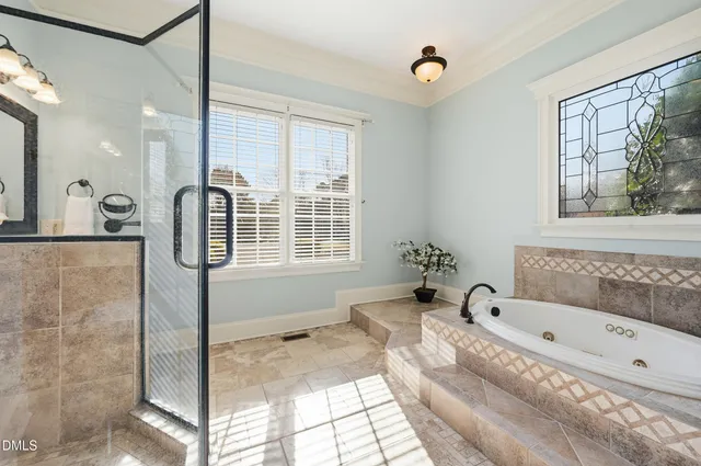 a view of a white house with a big yard and potted plants