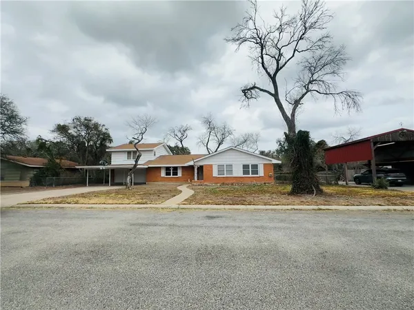 a view of a house with a yard covered in snow