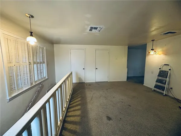 a view of an empty room with stairs