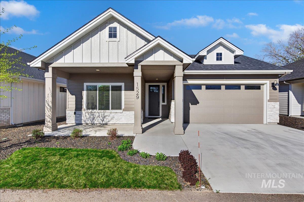 1529 North Parkshire Way Meridian, ID 83642 - Photo 1 of 1 View of front of property with stone siding, board and batten siding, an attached garage, driveway, and a shingled roof