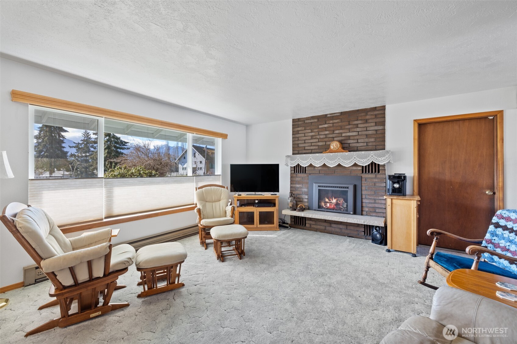 200 Lake Farm Road Port Angeles, WA 98362 - Photo 27 of 40 a living room with furniture a flat screen tv and a fireplace