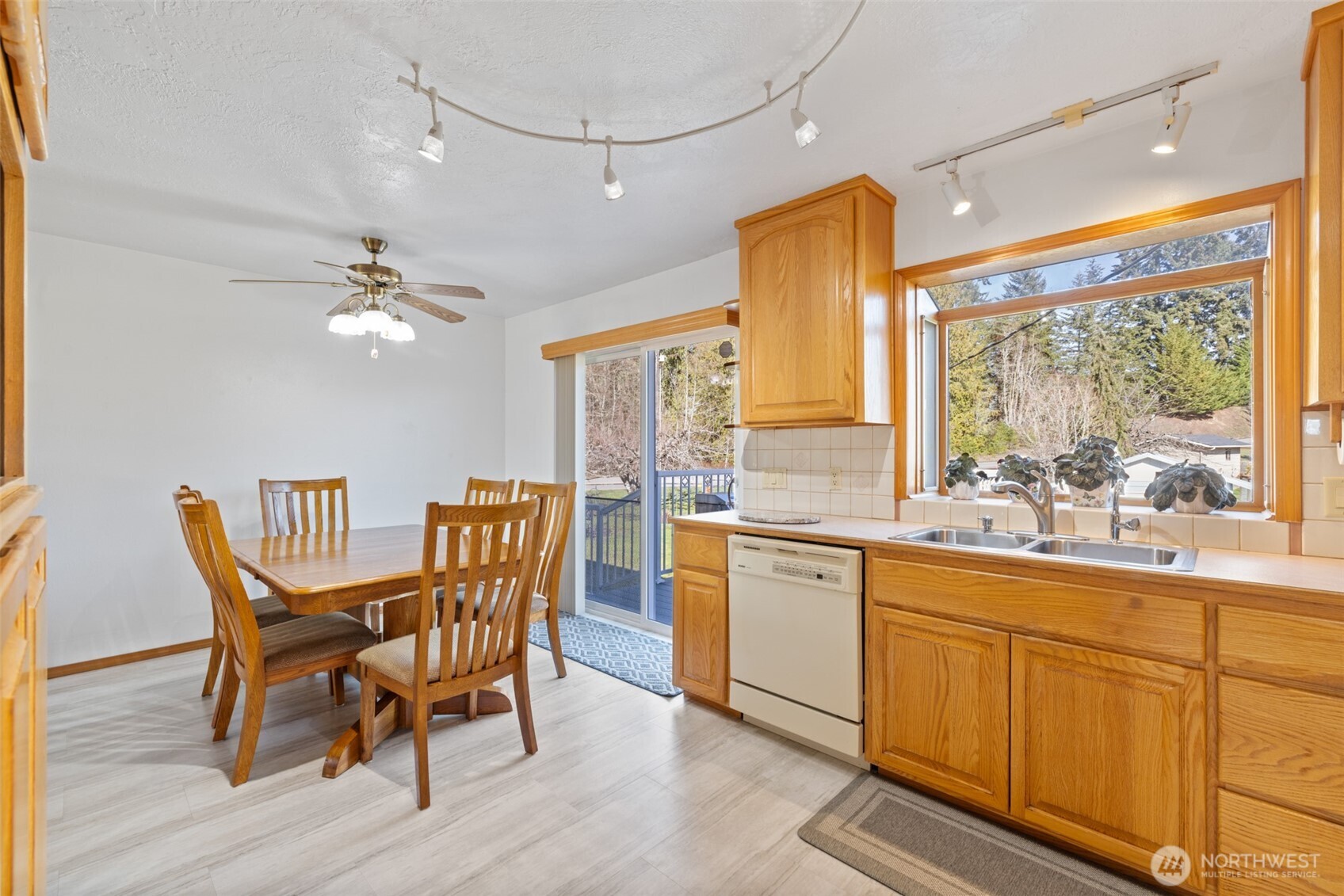 200 Lake Farm Road Port Angeles, WA 98362 - Photo 29 of 40 a dining room with wooden floor a chandelier a wooden table and chairs