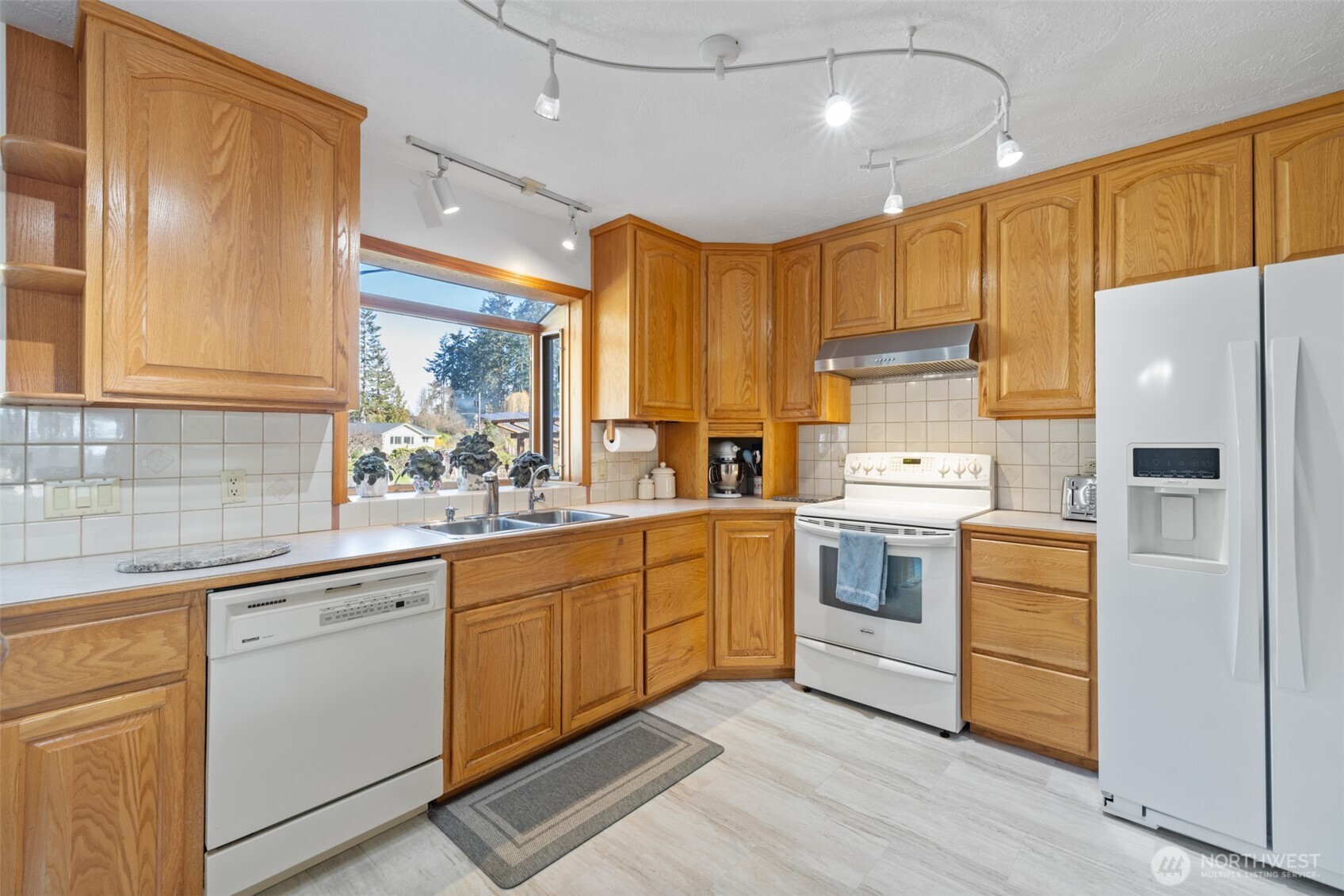 200 Lake Farm Road Port Angeles, WA 98362 - Photo 30 of 40 a kitchen with white cabinets and white appliances