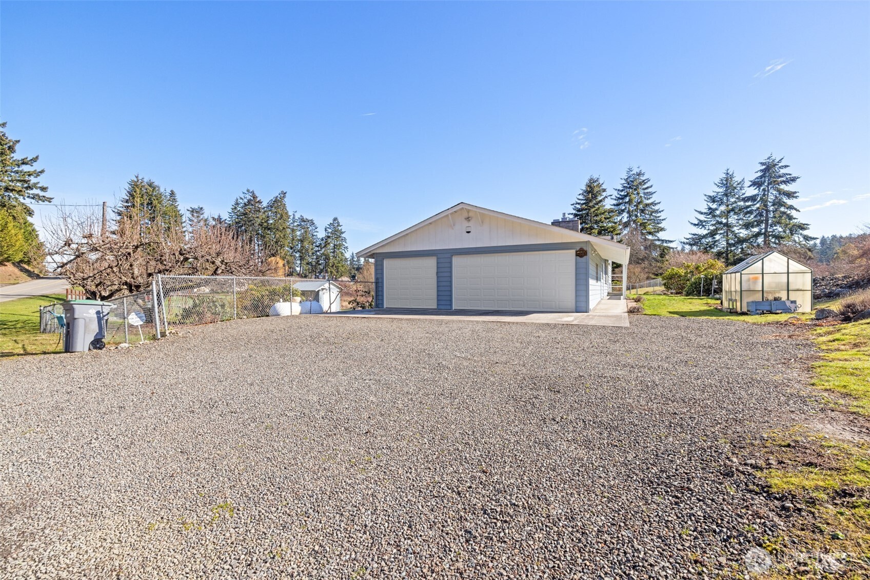 200 Lake Farm Road Port Angeles, WA 98362 - Photo 3 of 40 a front view of a house with a yard and garage