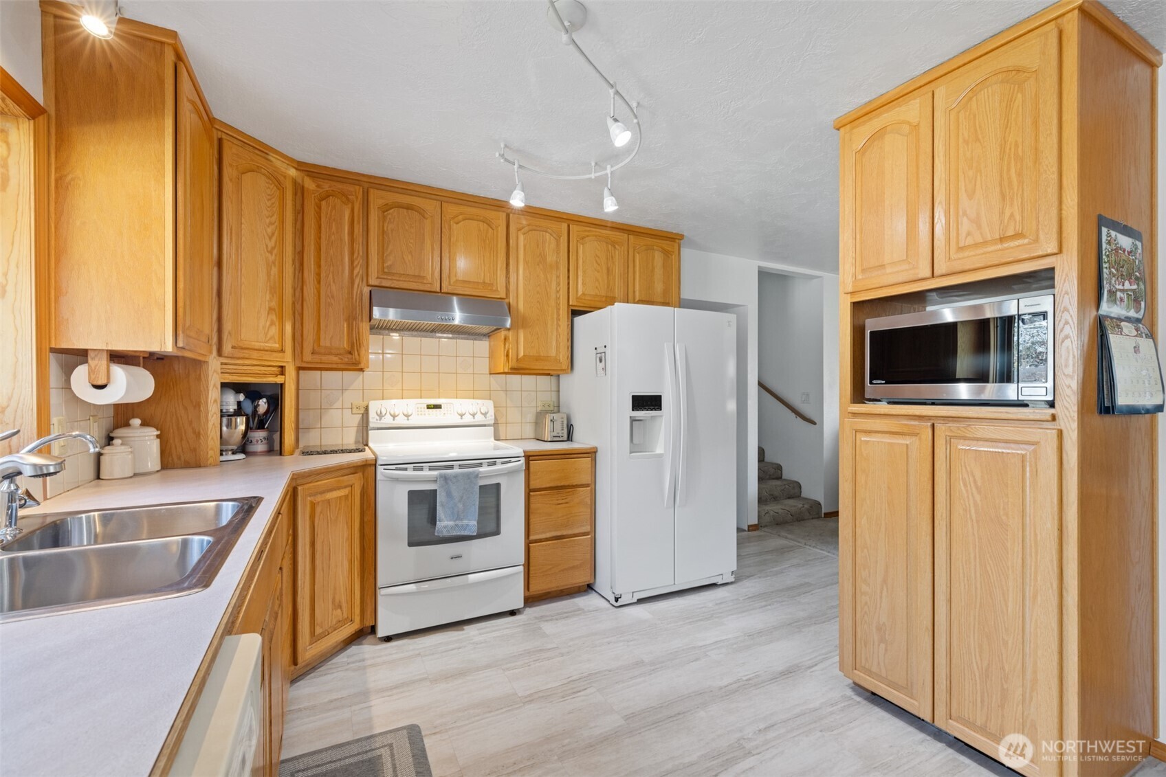 200 Lake Farm Road Port Angeles, WA 98362 - Photo 31 of 40 a kitchen with a sink a stove and a refrigerator