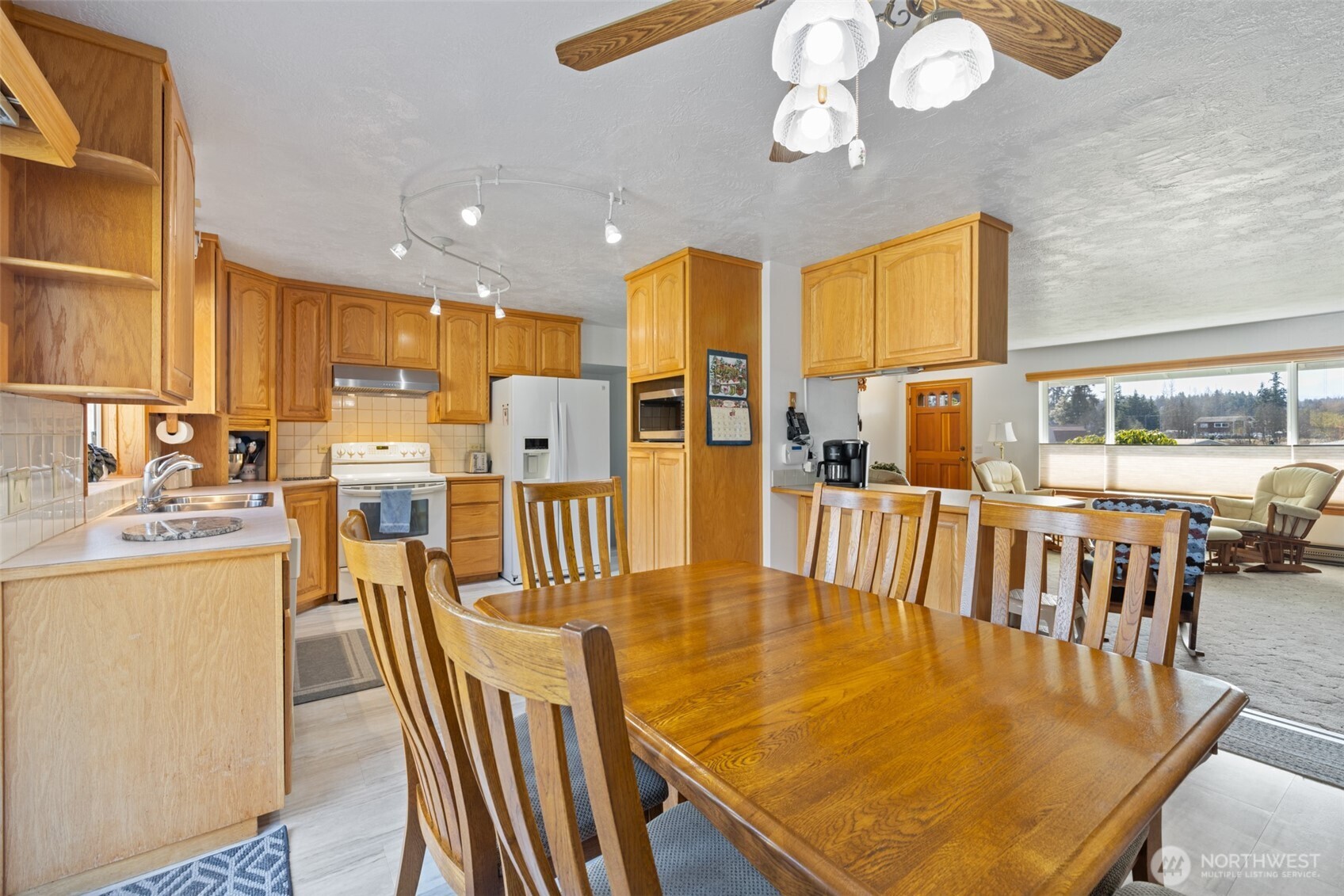 200 Lake Farm Road Port Angeles, WA 98362 - Photo 32 of 40 a dining room with furniture a large window and wooden floor