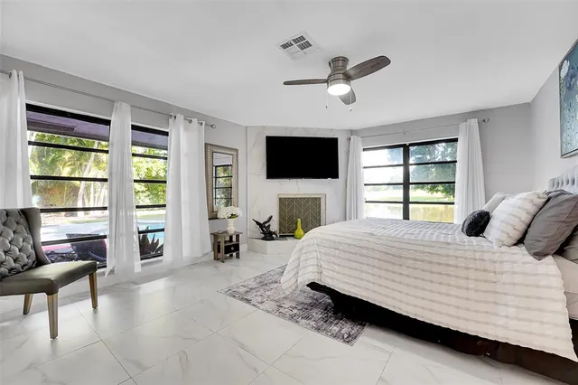 a bedroom with a large bed and a flat screen tv