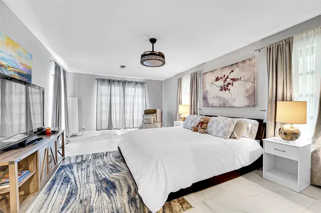 a bedroom with a large bed and a window