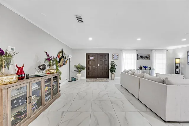 a large white kitchen with cabinets