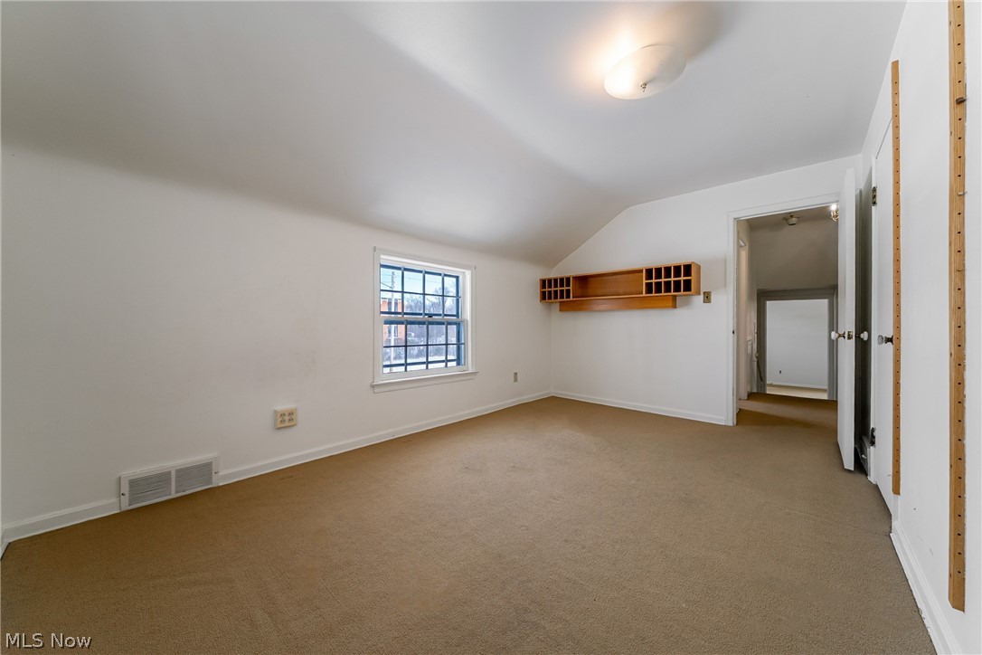 4602 College Road South Euclid, OH 44121 - Photo 20 of 26 Bonus room with vaulted ceiling and carpet floors