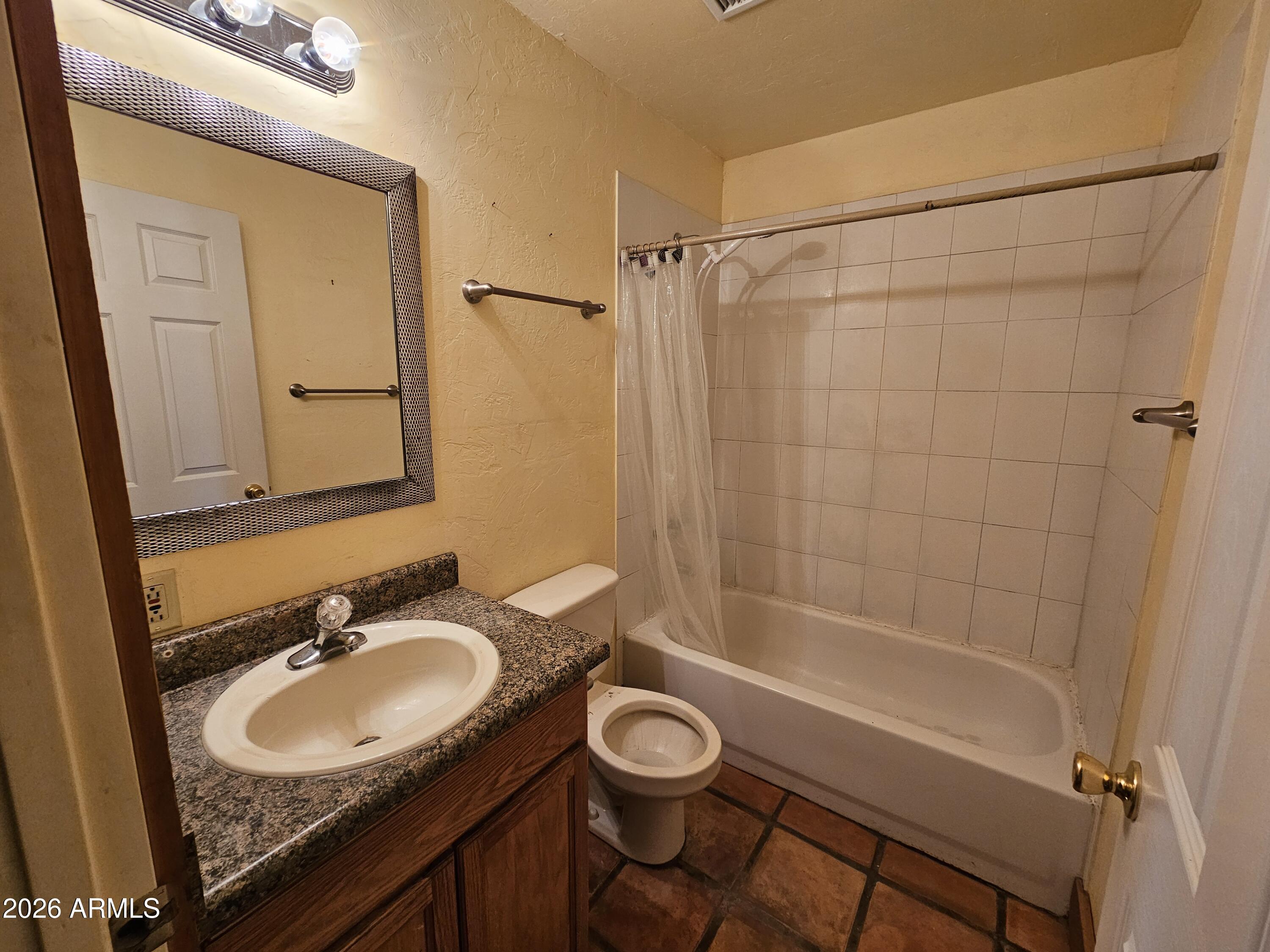 4105 North Washington Avenue Douglas, AZ 85607 - Photo 42 of 61 a bathroom with a granite countertop sink toilet a mirror and shower