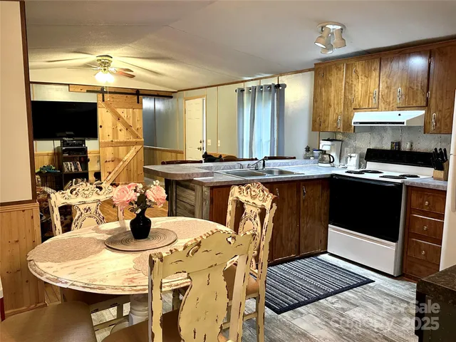 a kitchen with a sink a stove and chairs
