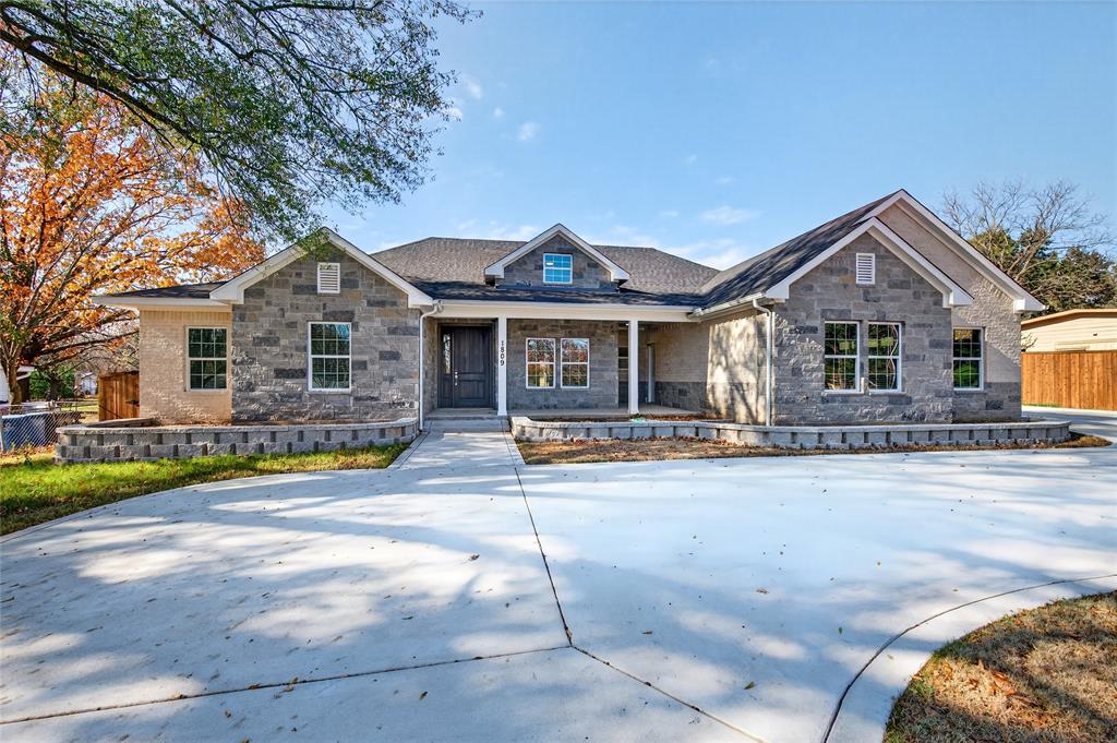 1809 Bluebonnet Avenue Denison, TX 75020 - Photo 1 of 40 a front view of a house with a yard and garage