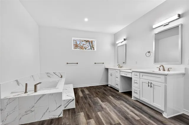 a spacious bathroom with a sink and a large mirror