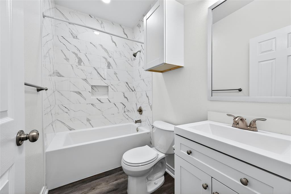 1809 Bluebonnet Avenue Denison, TX 75020 - Photo 28 of 40 a bathroom with a sink toilet and shower