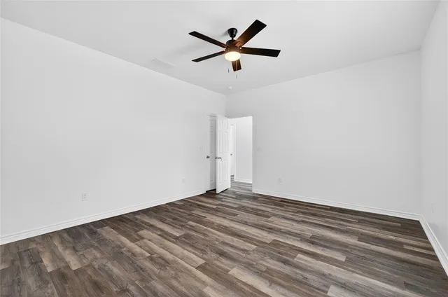 a view of empty room with ceiling fan