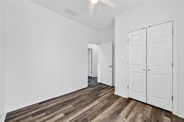 a view of a room with wooden floor