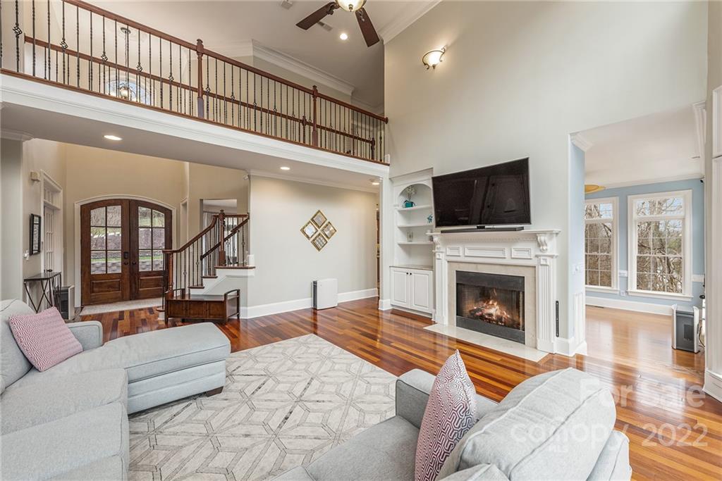 15501 Eagleview Drive Charlotte, NC 28278 - Photo 14 of 40 a living room with furniture a flat screen tv and a fireplace