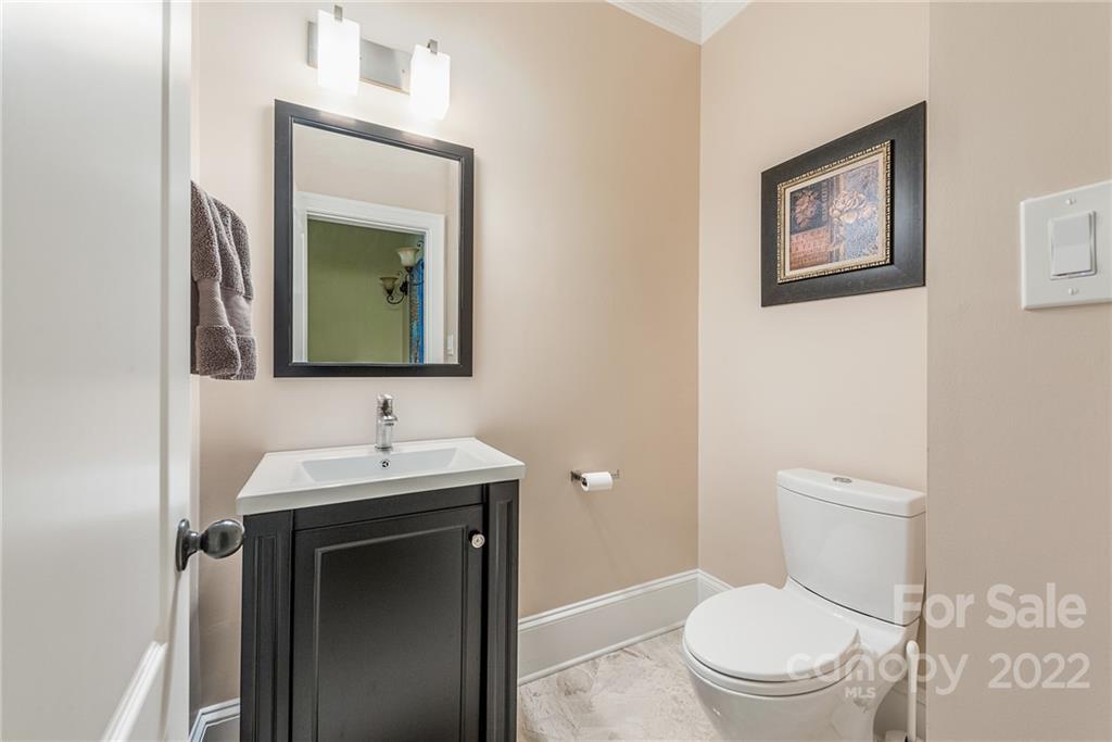 15501 Eagleview Drive Charlotte, NC 28278 - Photo 18 of 40 a bathroom with a toilet a sink and mirror